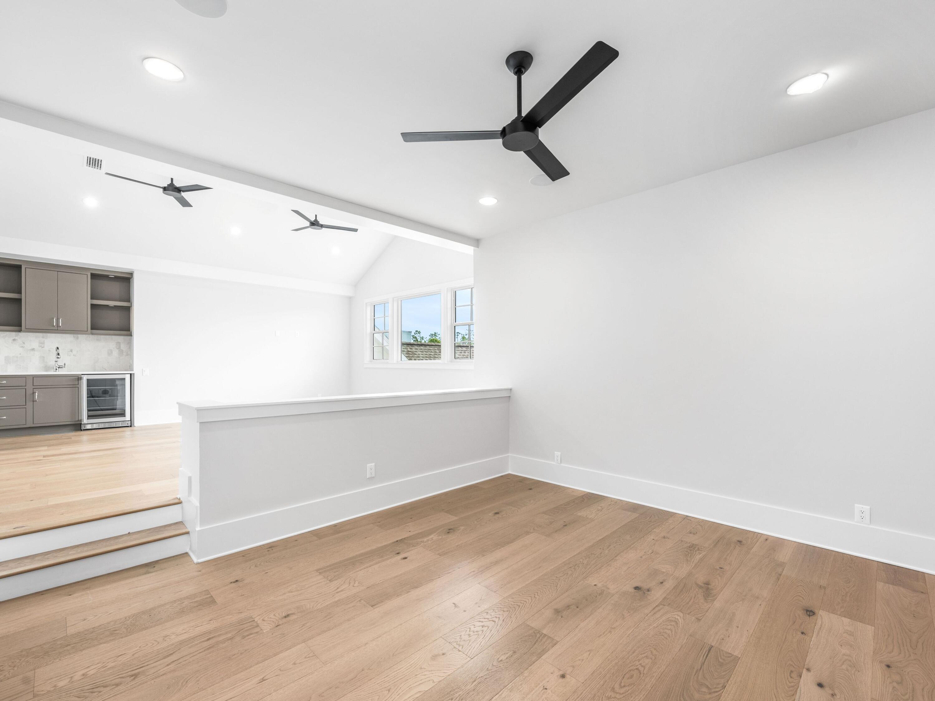 303 Golfridge Drive Watersound, FL 32461 - Photo 34 of 50 an empty room with wooden floor and windows