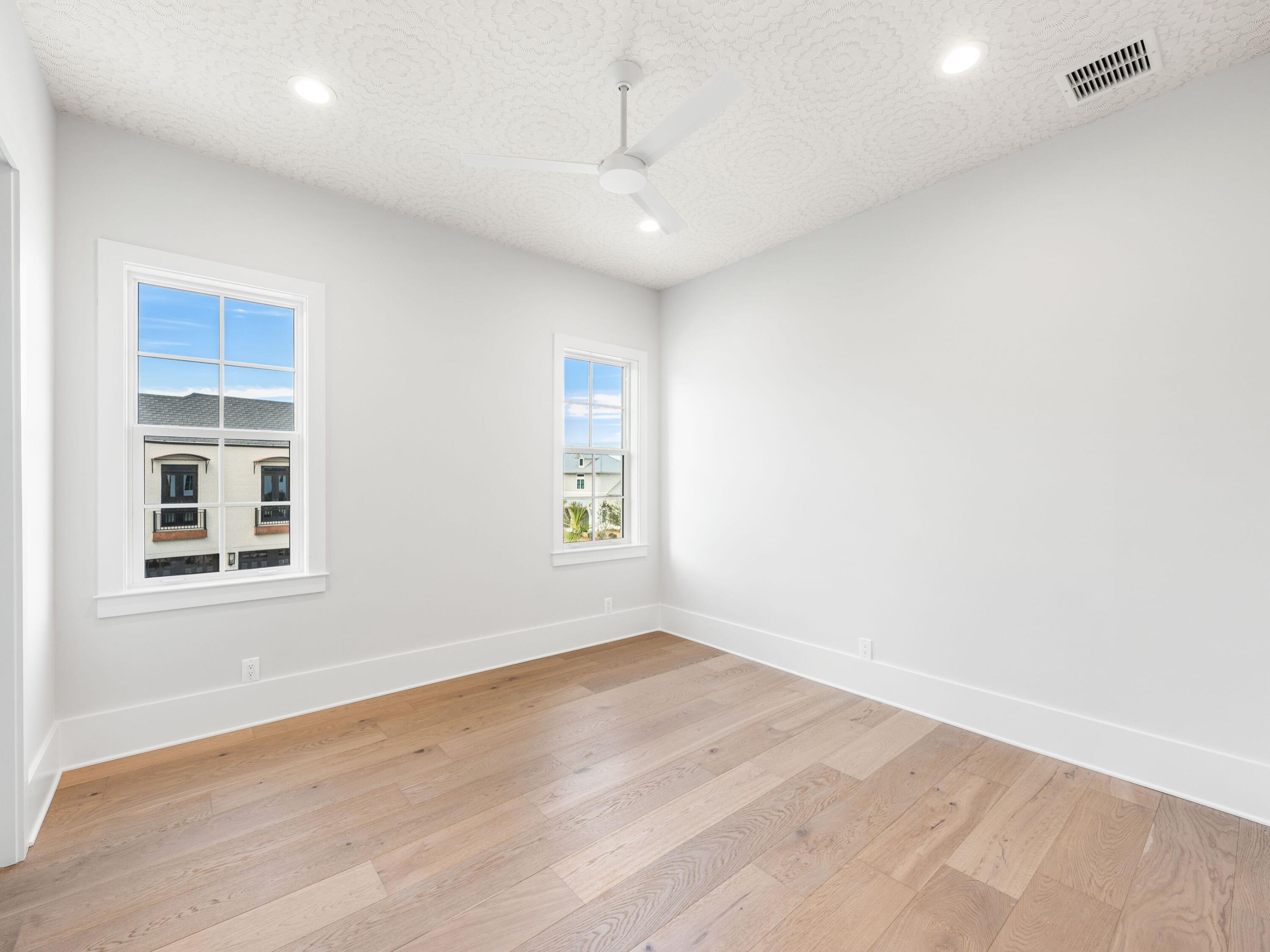 303 Golfridge Drive Watersound, FL 32461 - Photo 38 of 50 an empty room with wooden floor and windows