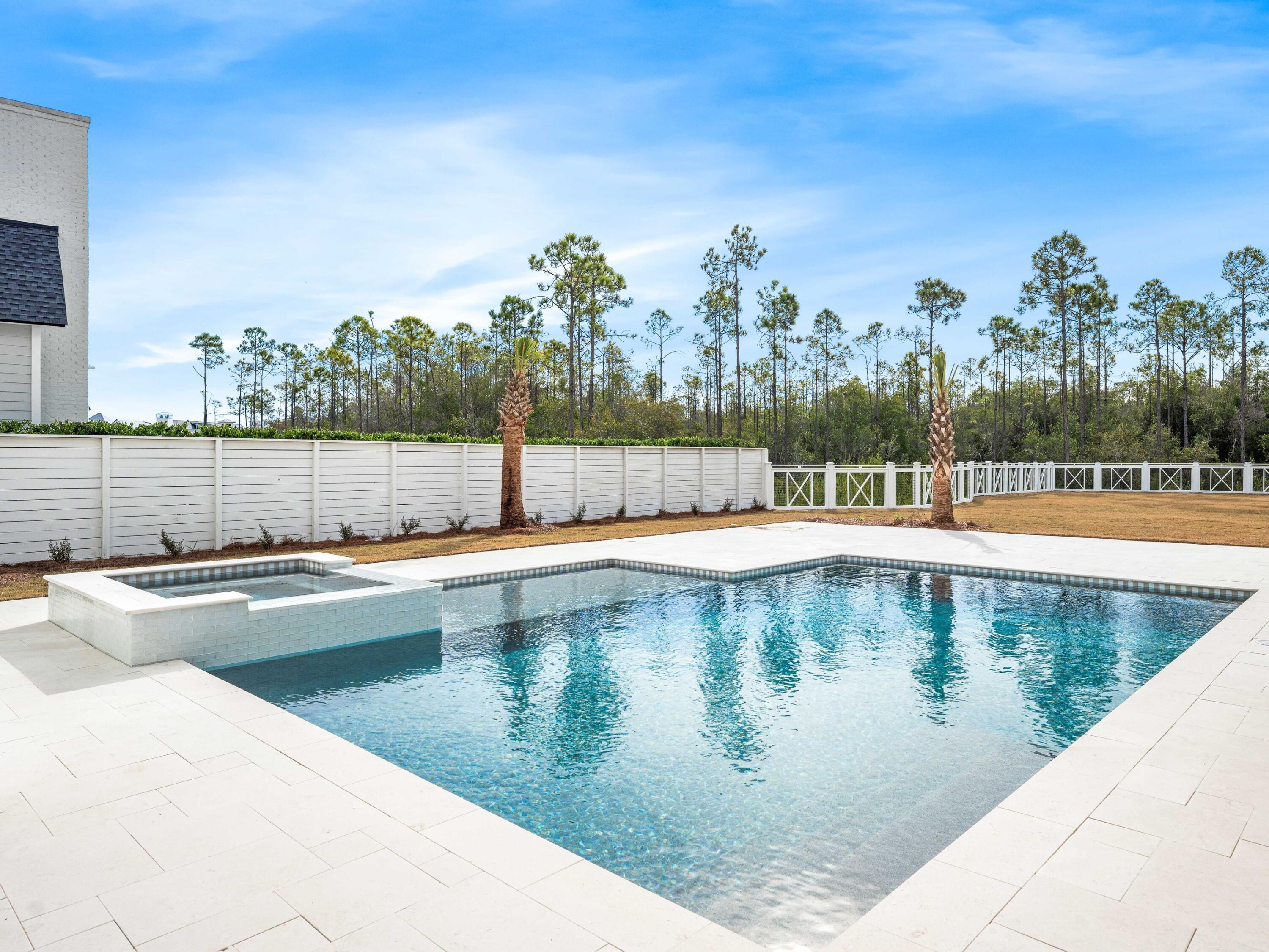 303 Golfridge Drive Watersound, FL 32461 - Photo 4 of 50 a view of a swimming pool with outdoor seating and yard in the back