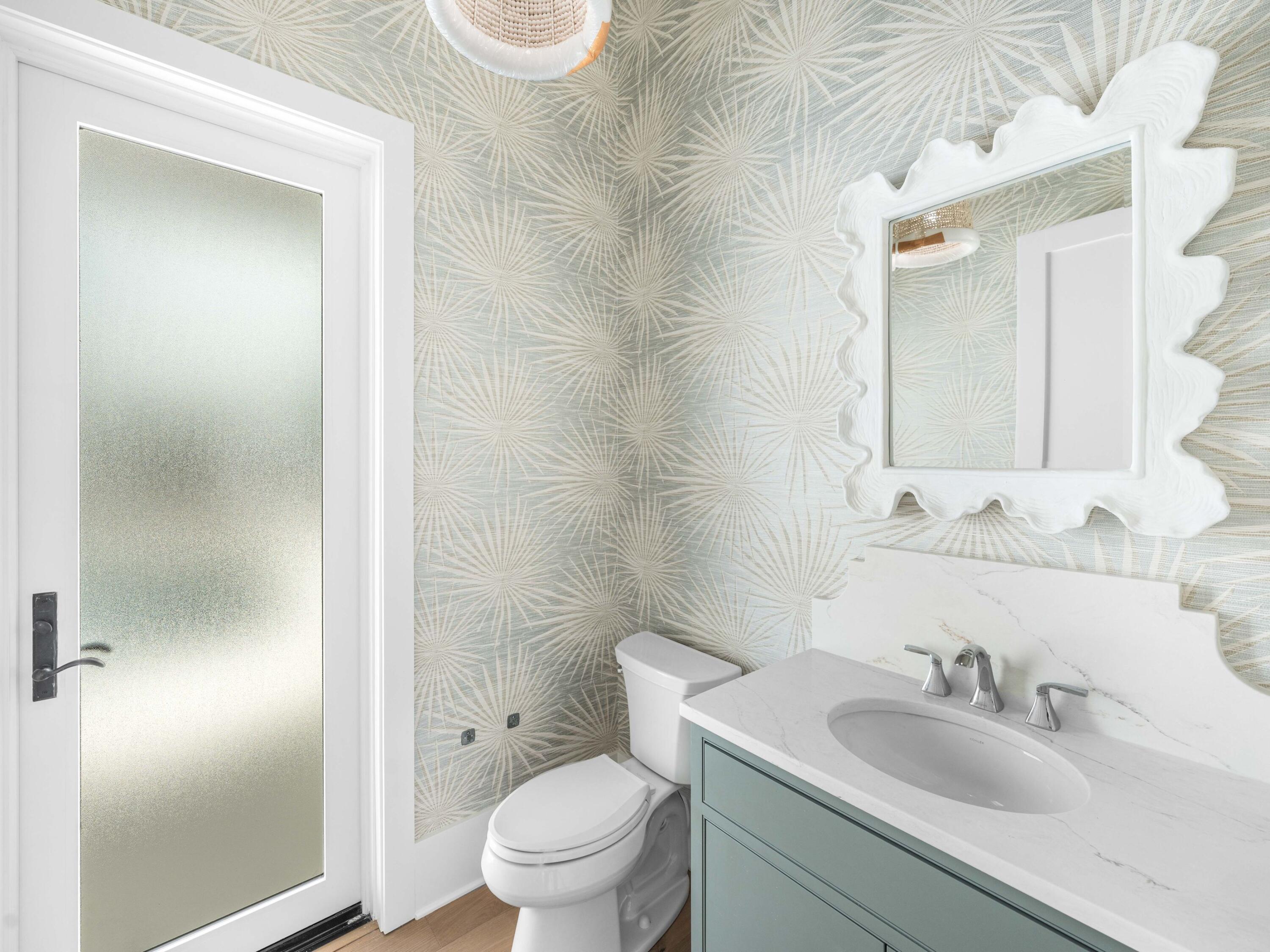 303 Golfridge Drive Watersound, FL 32461 - Photo 42 of 50 a bathroom with a toilet sink vanity and mirror