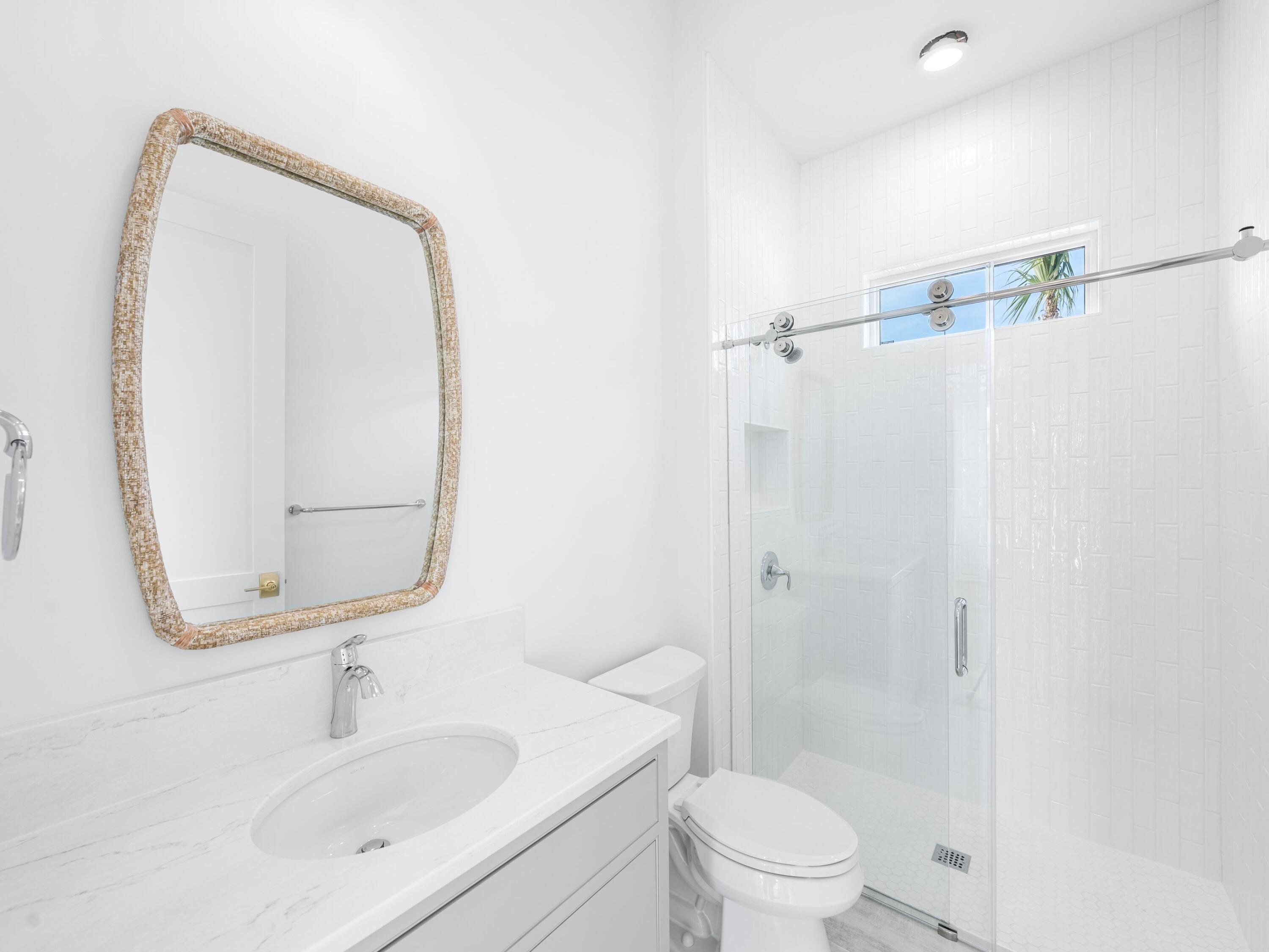 303 Golfridge Drive Watersound, FL 32461 - Photo 45 of 50 a bathroom with a sink toilet and shower