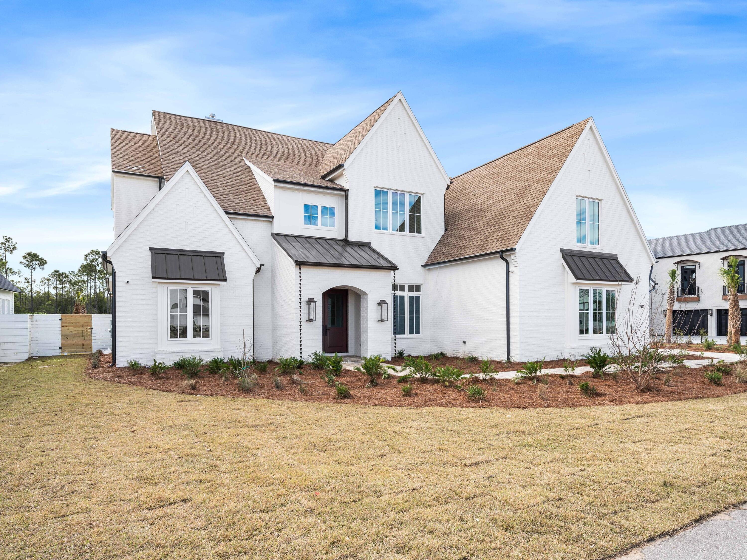 303 Golfridge Drive Watersound, FL 32461 - Photo 46 of 50 a front view of a house with a yard