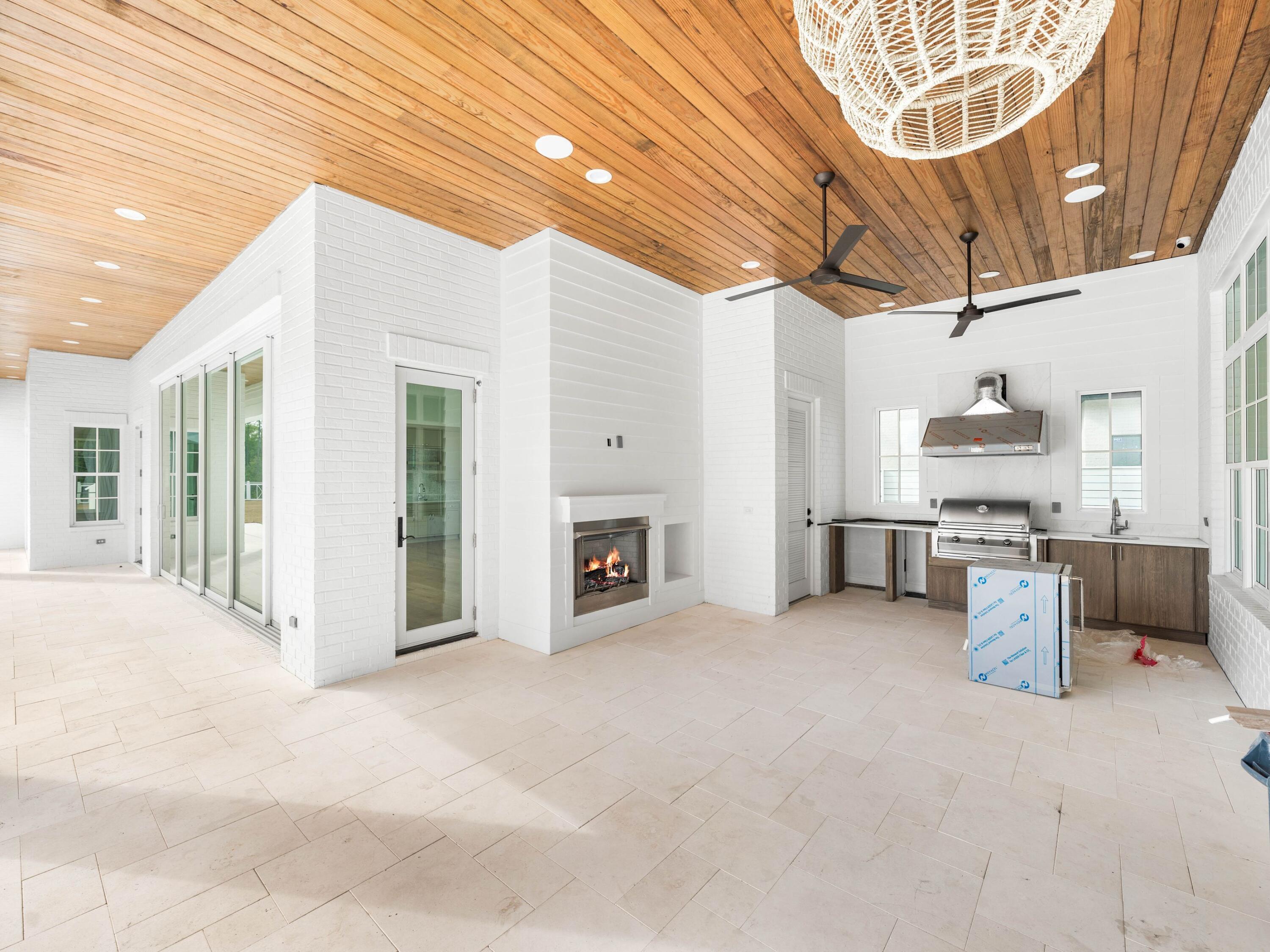 303 Golfridge Drive Watersound, FL 32461 - Photo 5 of 50 a view of a livingroom with furniture and a fireplace