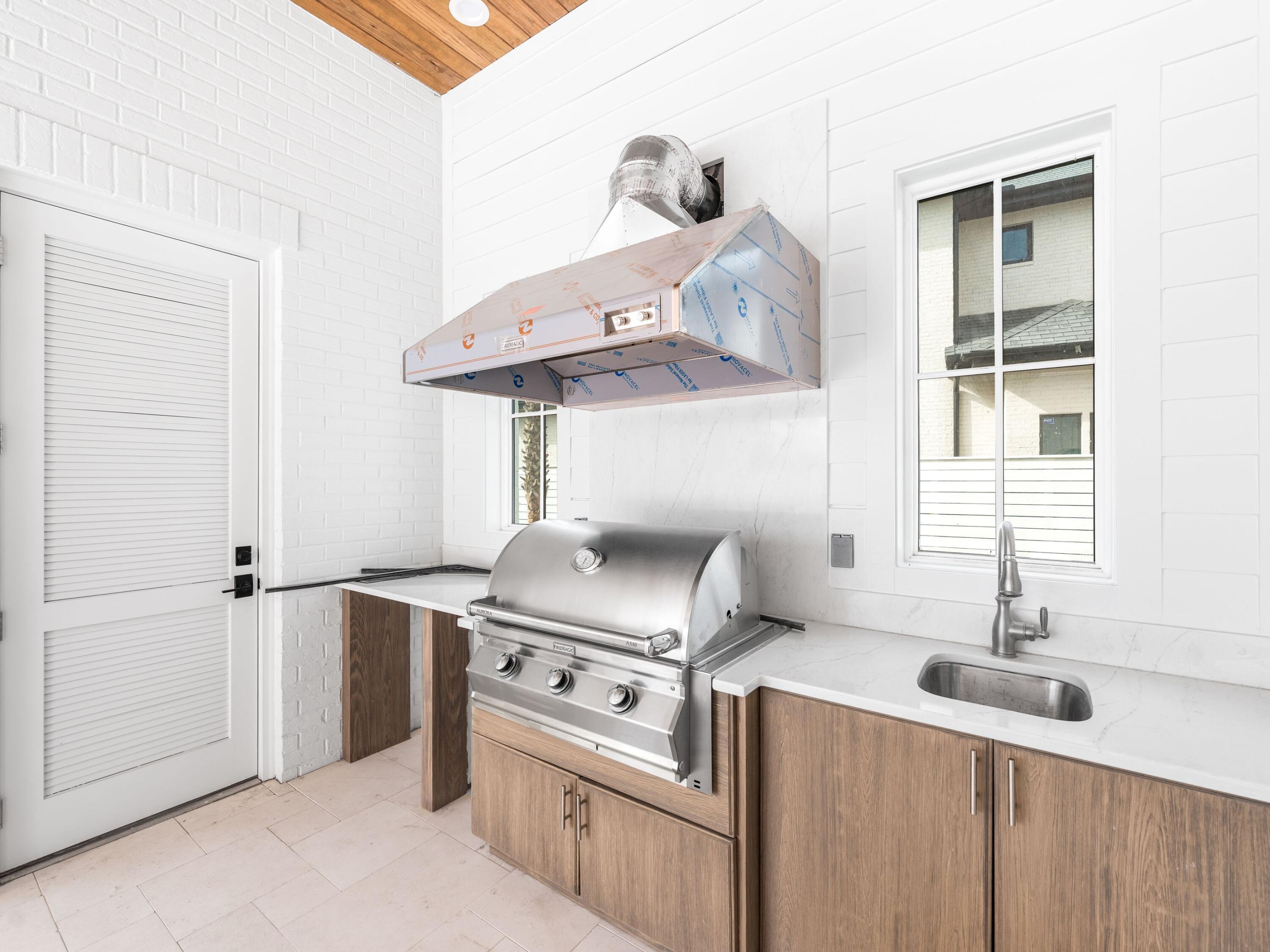 303 Golfridge Drive Watersound, FL 32461 - Photo 6 of 50 a kitchen with a stove and a sink