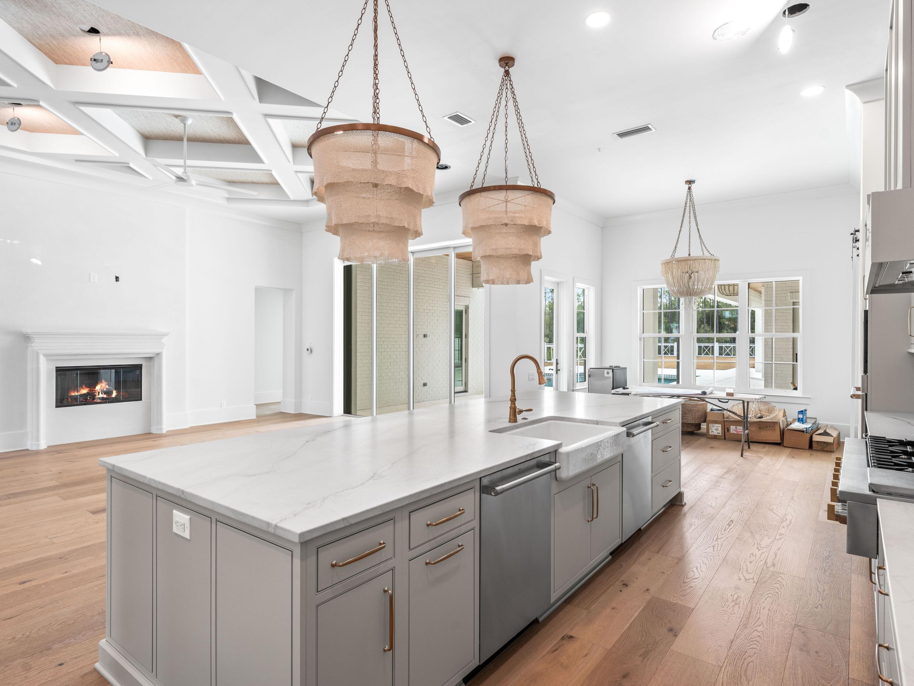 303 Golfridge Drive Watersound, FL 32461 - Photo 9 of 50 a kitchen with sink cabinets and wooden floor