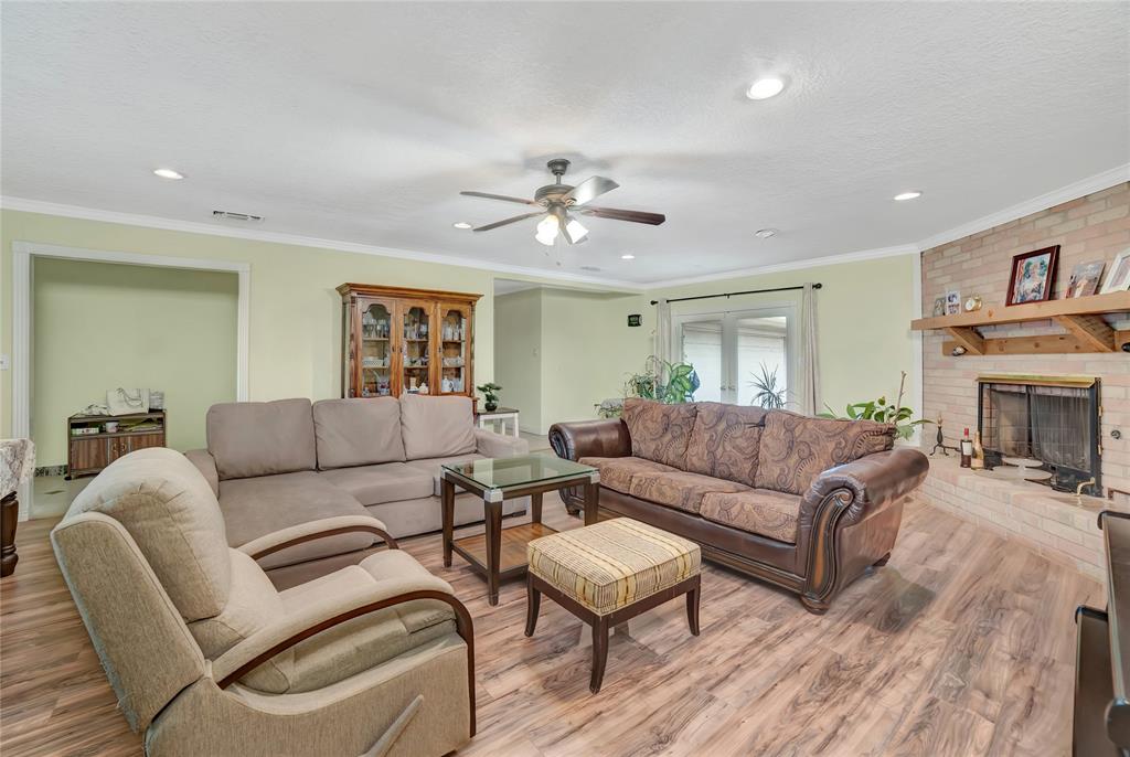 6021 Sycamore Creek Road Edgecliff Village, TX 76134 - Photo 12 of 37 Living room featuring wood finished floors, ceiling fan, recessed lighting, ornamental molding, and a fireplace