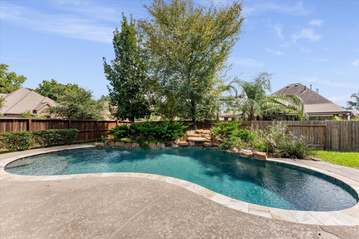18843 Collins View Drive New Caney, TX 77357 - Photo 42 of 50 Lagoon shaped pool with fountain feature surrounded by beautiful greenary and flowers give a relaxing and great view to enjoy