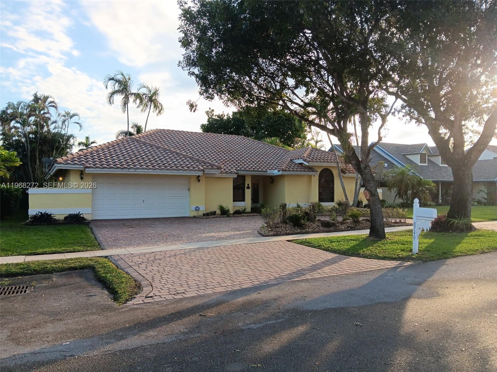 8740 Southwest 56th Place Cooper City, FL 33328 - Photo 1 of 54 a front view of a house with garden