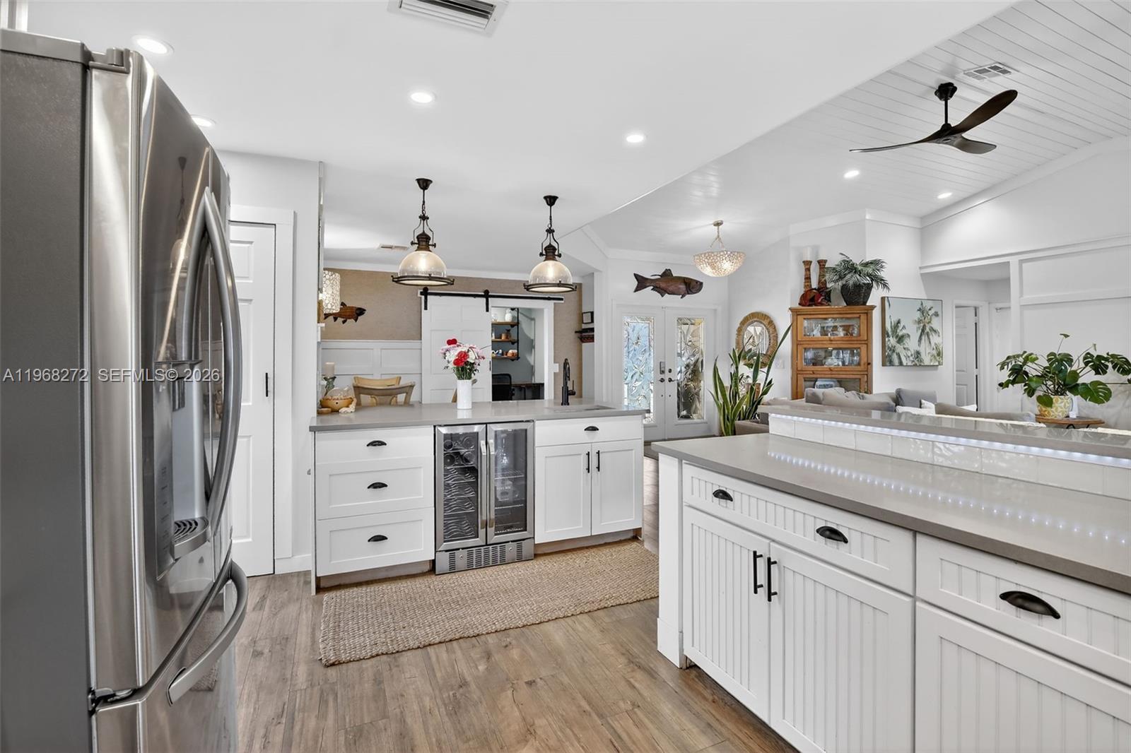 8740 Southwest 56th Place Cooper City, FL 33328 - Photo 14 of 54 a kitchen with stainless steel appliances kitchen island granite countertop a refrigerator and a sink