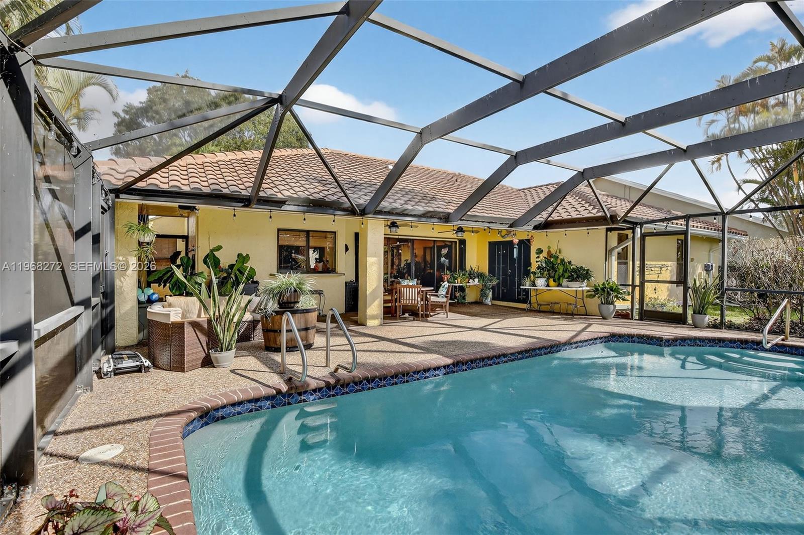 8740 Southwest 56th Place Cooper City, FL 33328 - Photo 19 of 54 a view of a swimming pool with a patio