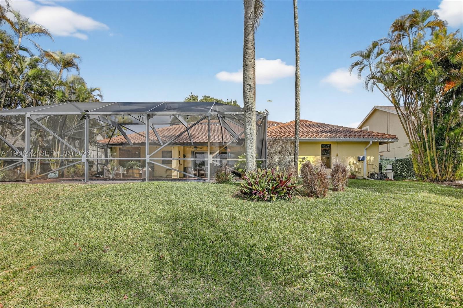 8740 Southwest 56th Place Cooper City, FL 33328 - Photo 21 of 54 a front view of a house with garden