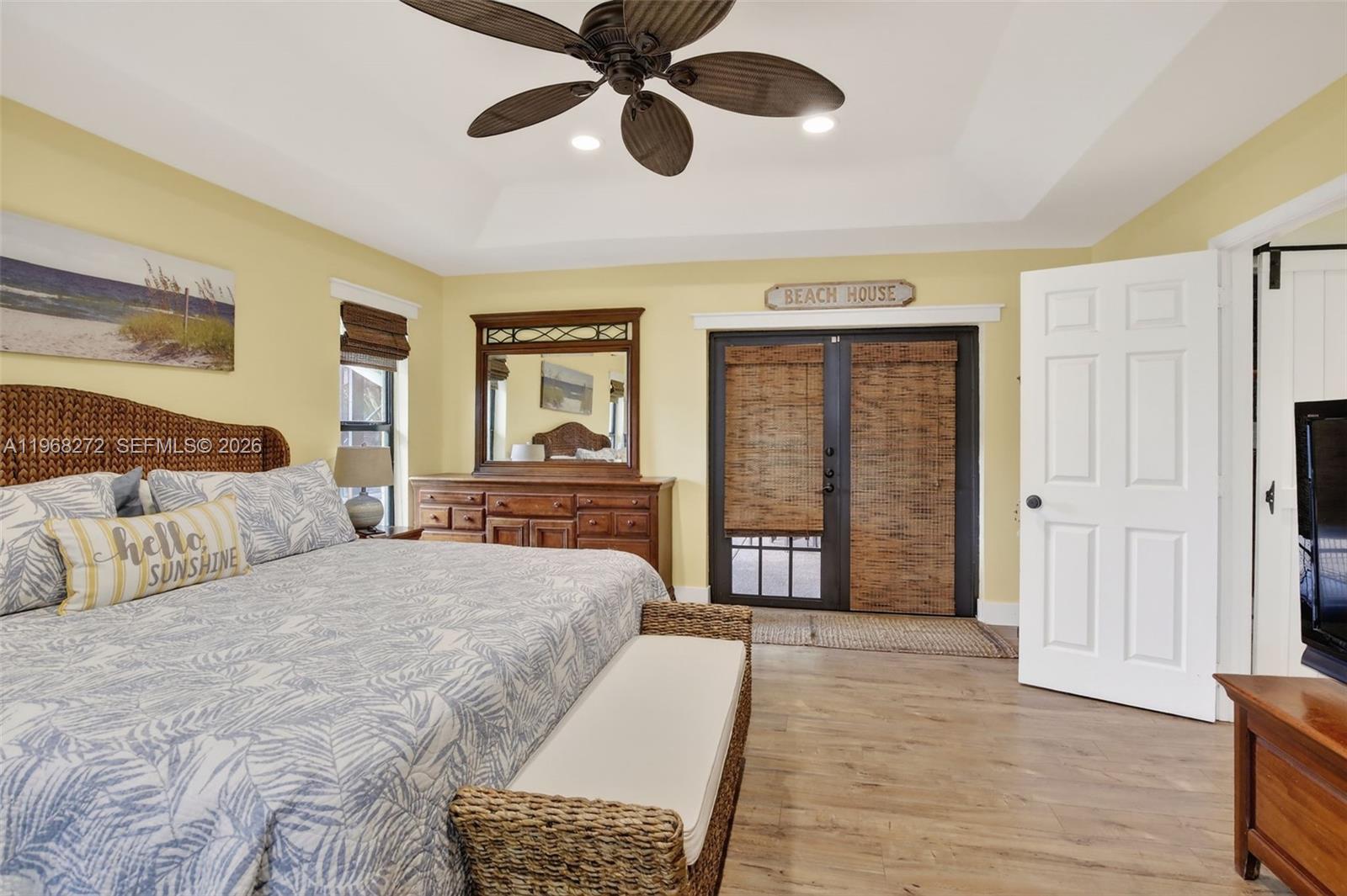 8740 Southwest 56th Place Cooper City, FL 33328 - Photo 36 of 54 a bedroom with a large bed chandelier and a window