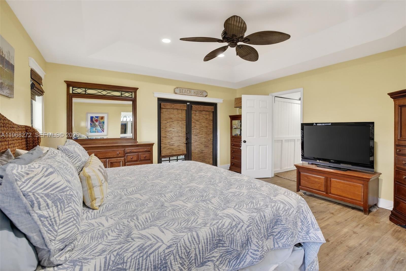 8740 Southwest 56th Place Cooper City, FL 33328 - Photo 37 of 54 a bedroom with a bed and a flat screen tv on dresser