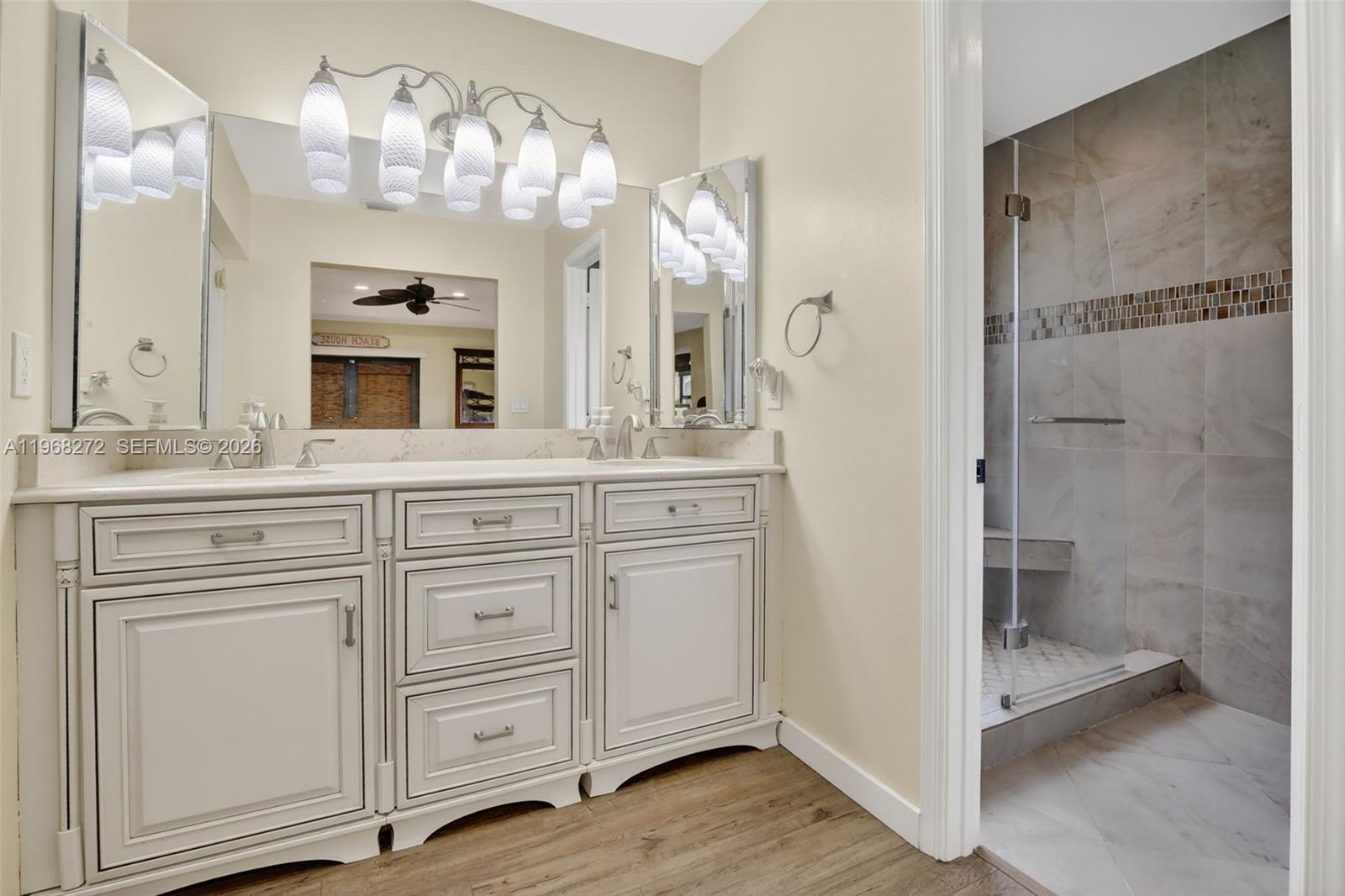 8740 Southwest 56th Place Cooper City, FL 33328 - Photo 38 of 54 a bathroom with a double vanity sink and a mirror