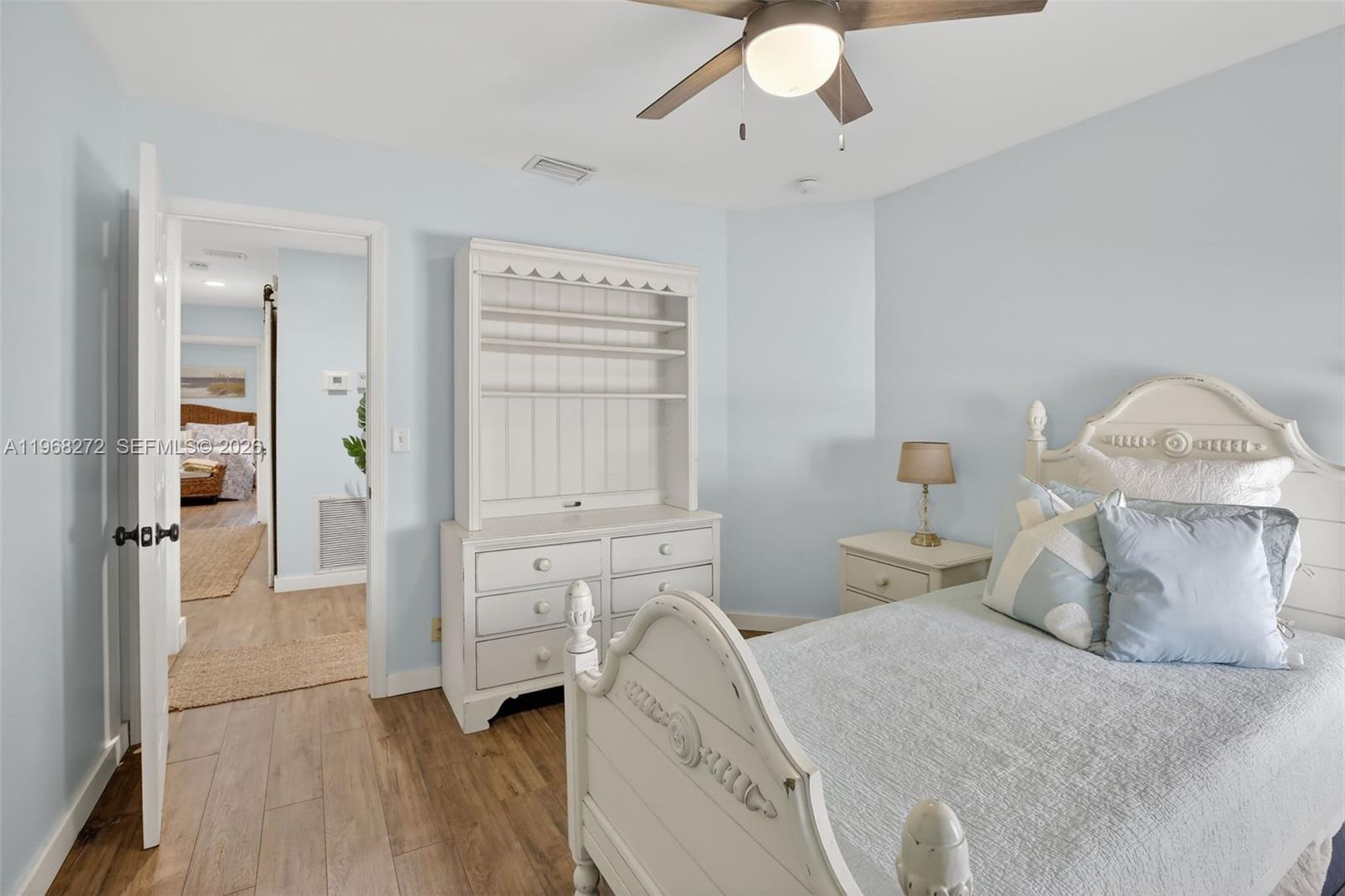 8740 Southwest 56th Place Cooper City, FL 33328 - Photo 43 of 54 a bedroom with a bed and a chandelier