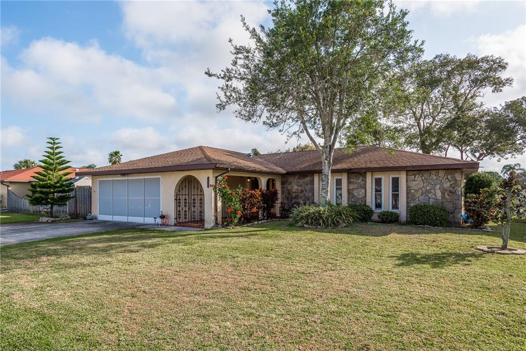 9736 San Vincente Way Port Richey, FL 34668 - Photo 1 of 1 a front view of a house with a yard