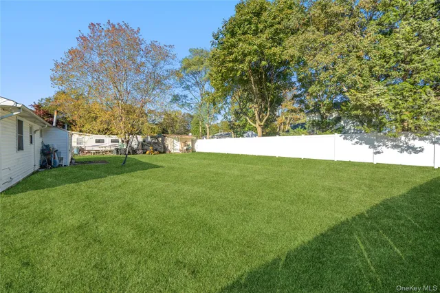 a view of yard with grass and trees