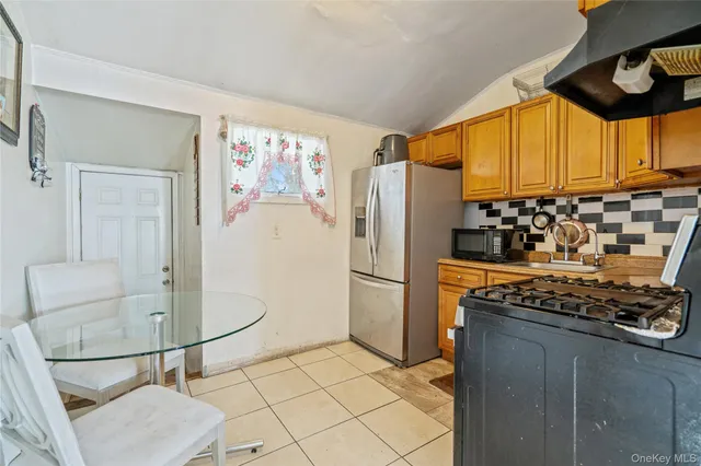 a kitchen with stainless steel appliances granite countertop a refrigerator and a stove top oven