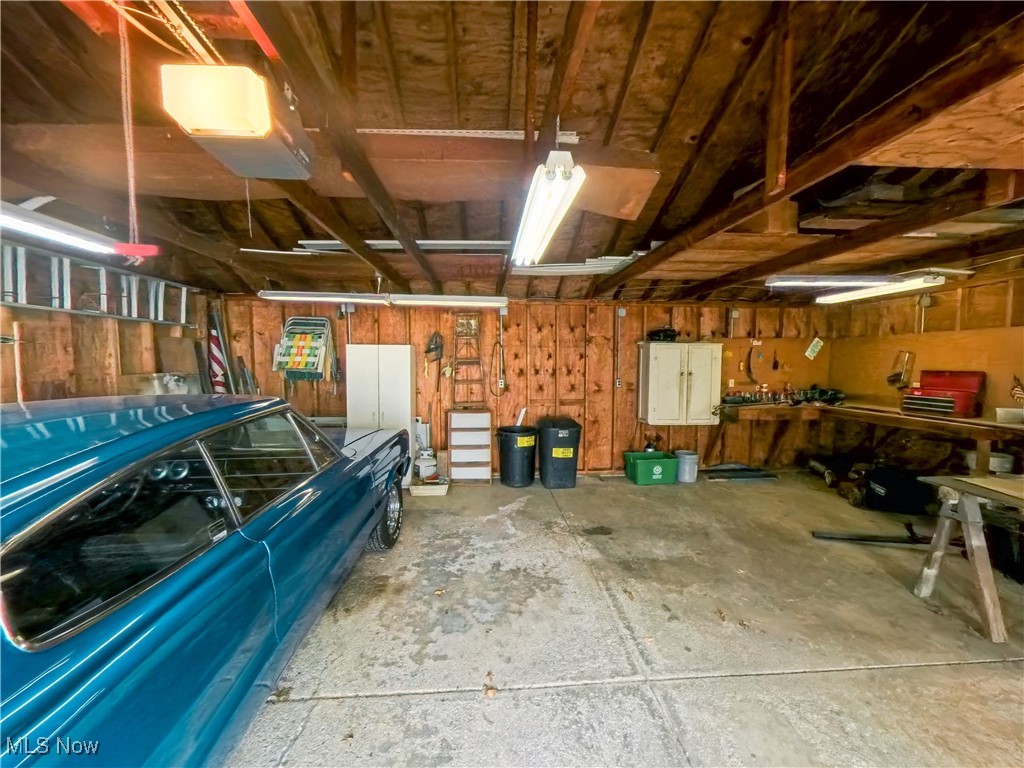 1668 Harwich Road Cleveland, OH 44124 - Photo 19 of 19 Garage with a garage door opener and a workshop area