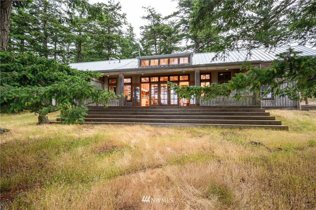 a front view of a house with a yard balcony
