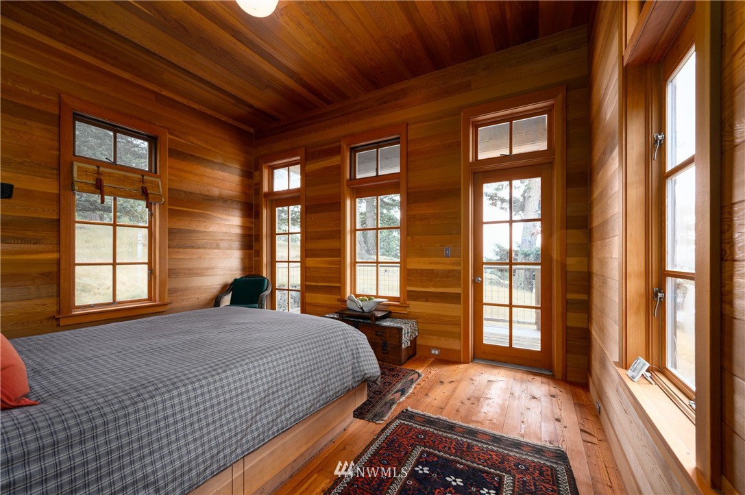 4-dh 4-dh 4-dh Decatur Street Northwest Anacortes, WA 98221 - Photo 13 of 24 a bedroom with a bed and a large window with balcony view