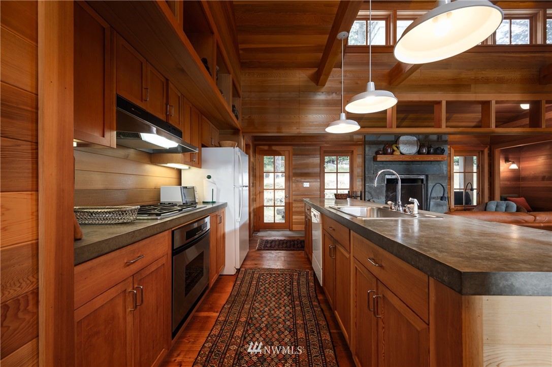 4-dh 4-dh 4-dh Decatur Street Northwest Anacortes, WA 98221 - Photo 10 of 24 a kitchen with stainless steel appliances granite countertop a stove and a sink