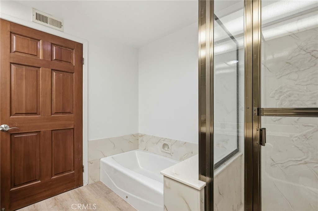 18233 Charlton Lane Porter Ranch, CA 91326 - Photo 16 of 40 a bathroom with a tub and shower