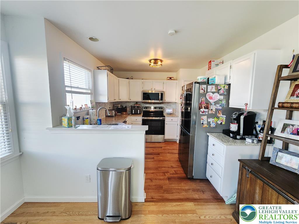 237 Ridings Circle Macungie, PA 18062 - Photo 21 of 70 Rich wood flooring runs seamlessly through this brightly illuminated, classic culinary space.