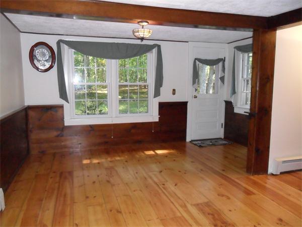 129 Red Acre Road Stow, MA 01775 - Photo 4 of 24 a view of an empty room with a window and wooden floor
