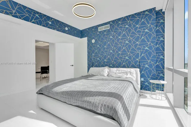 a bedroom with a large bed and a large window