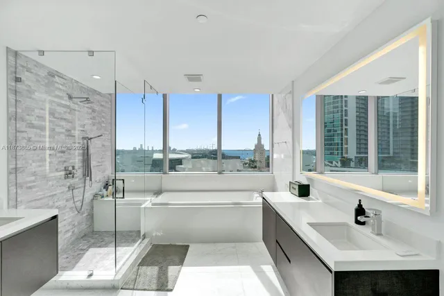 a view of bathroom with bathtub and shower