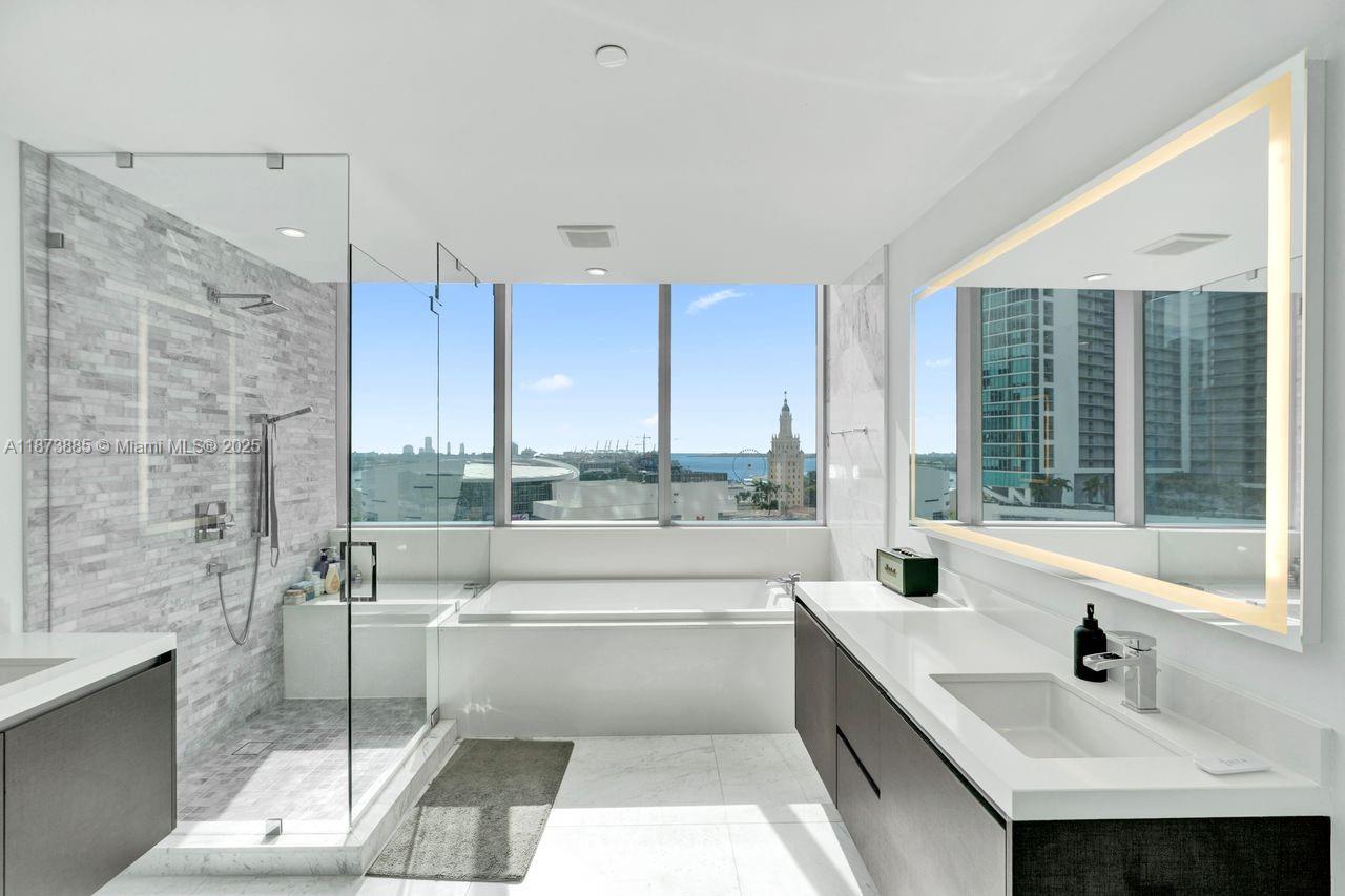 851 Northeast 1st Avenue, Unit 1411 Miami, FL 33132 - Photo 14 of 58 a bathroom with a bathtub and a sink