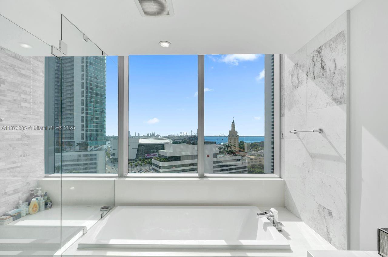 851 Northeast 1st Avenue, Unit 1411 Miami, FL 33132 - Photo 15 of 58 a view of bathroom with bathtub and shower
