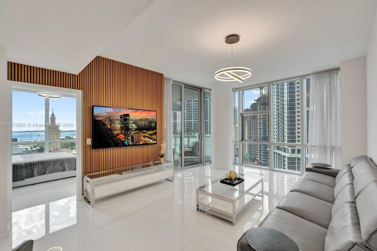 851 Northeast 1st Avenue, Unit 1411 Miami, FL 33132 - Photo 2 of 58 a living room with furniture and a large window