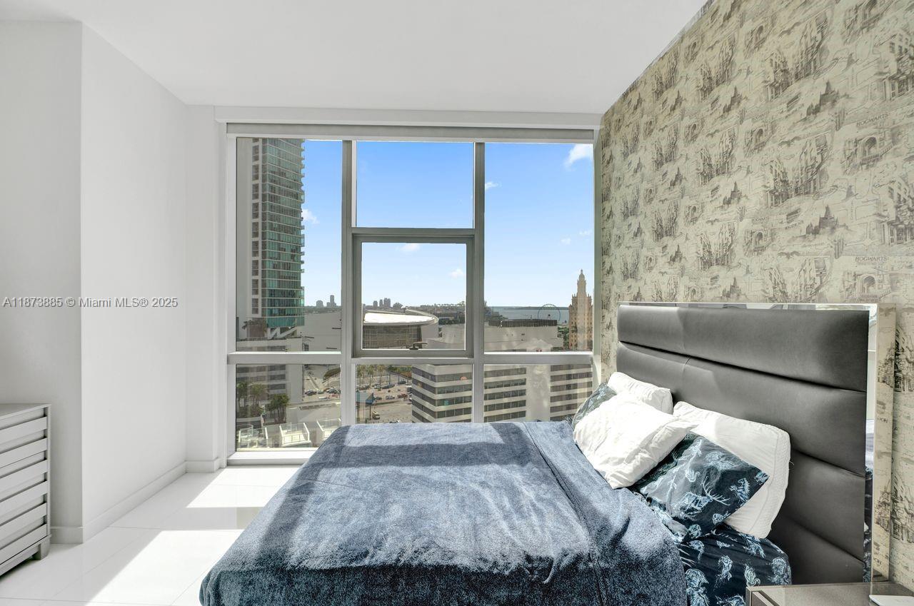 851 Northeast 1st Avenue, Unit 1411 Miami, FL 33132 - Photo 27 of 58 a bedroom with furniture and a large window