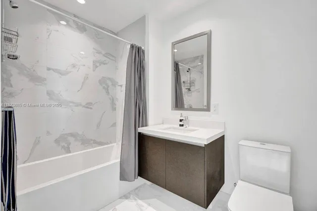 a large bed sitting in a room next to a lamp