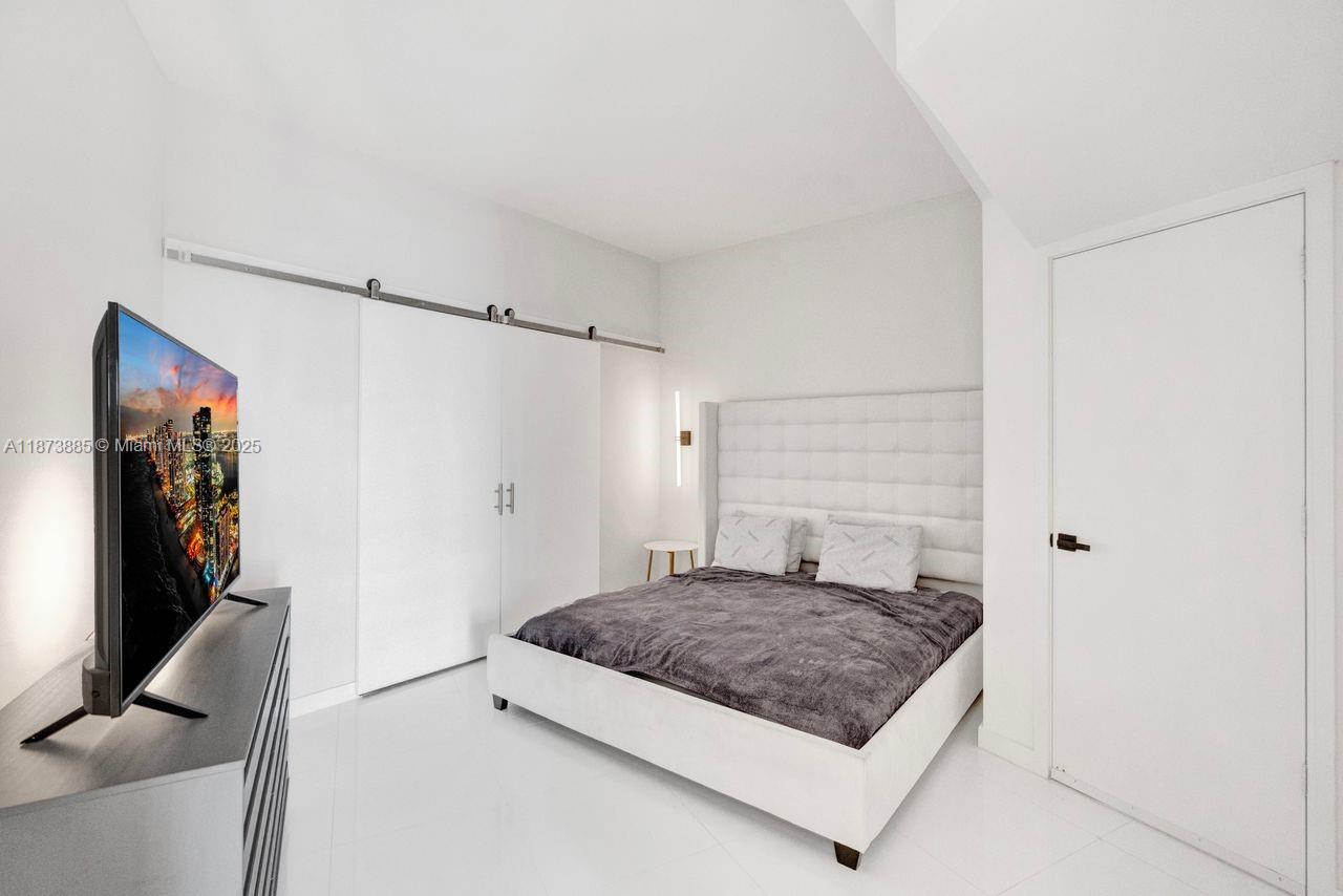 851 Northeast 1st Avenue, Unit 1411 Miami, FL 33132 - Photo 32 of 58 a living room with furniture and a flat screen tv