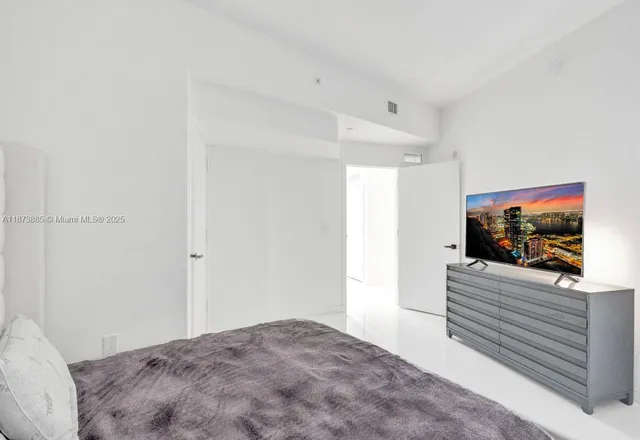 a view of a hallway with wooden floor and chandelier