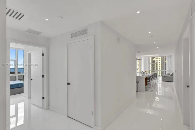 a view of a tall building with a palm tree next to a tall building