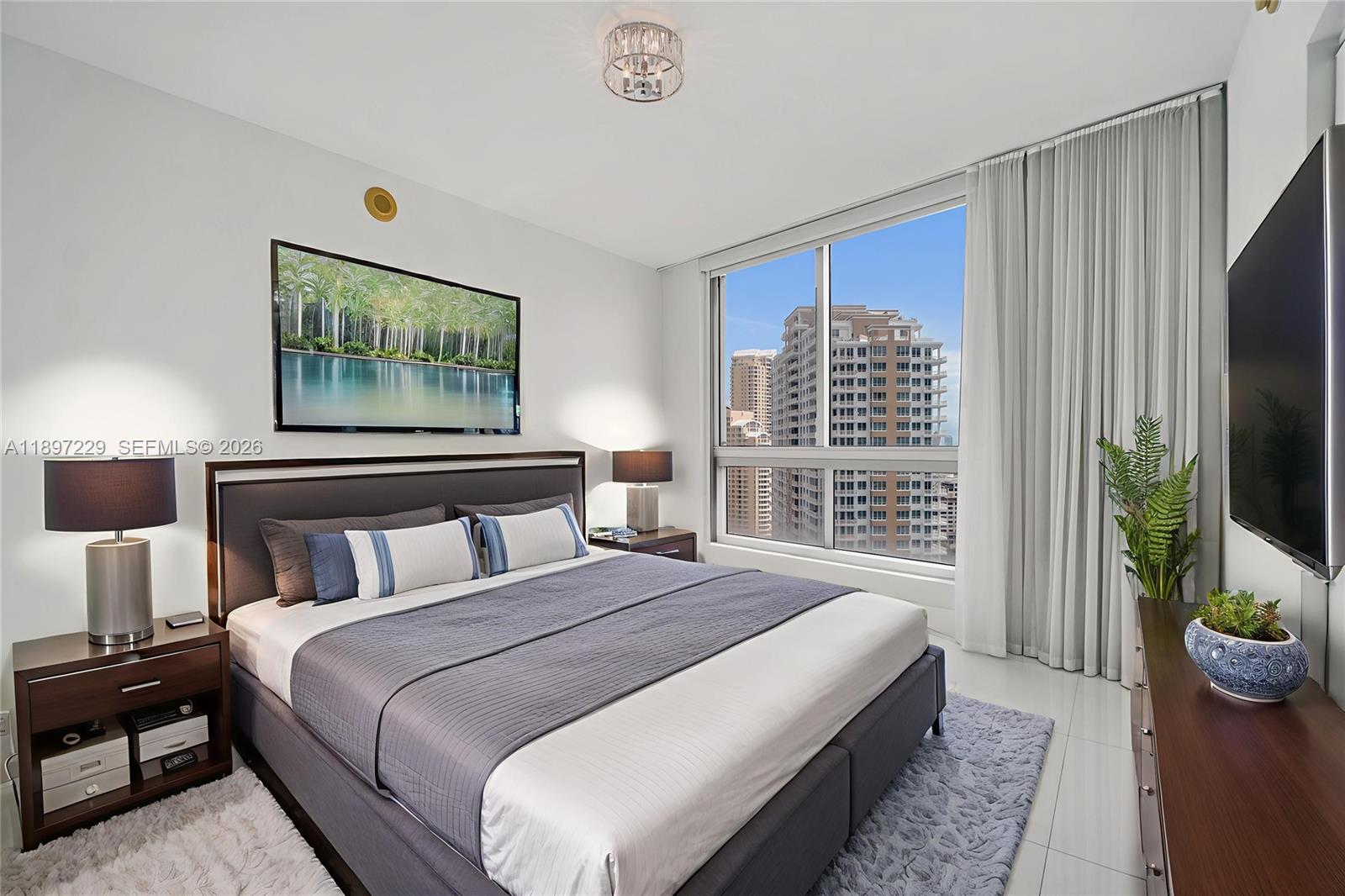 495 Brickell Avenue, Unit 2301 Miami, FL 33131 - Photo 13 of 61 a bedroom with bed and a flat tv screen