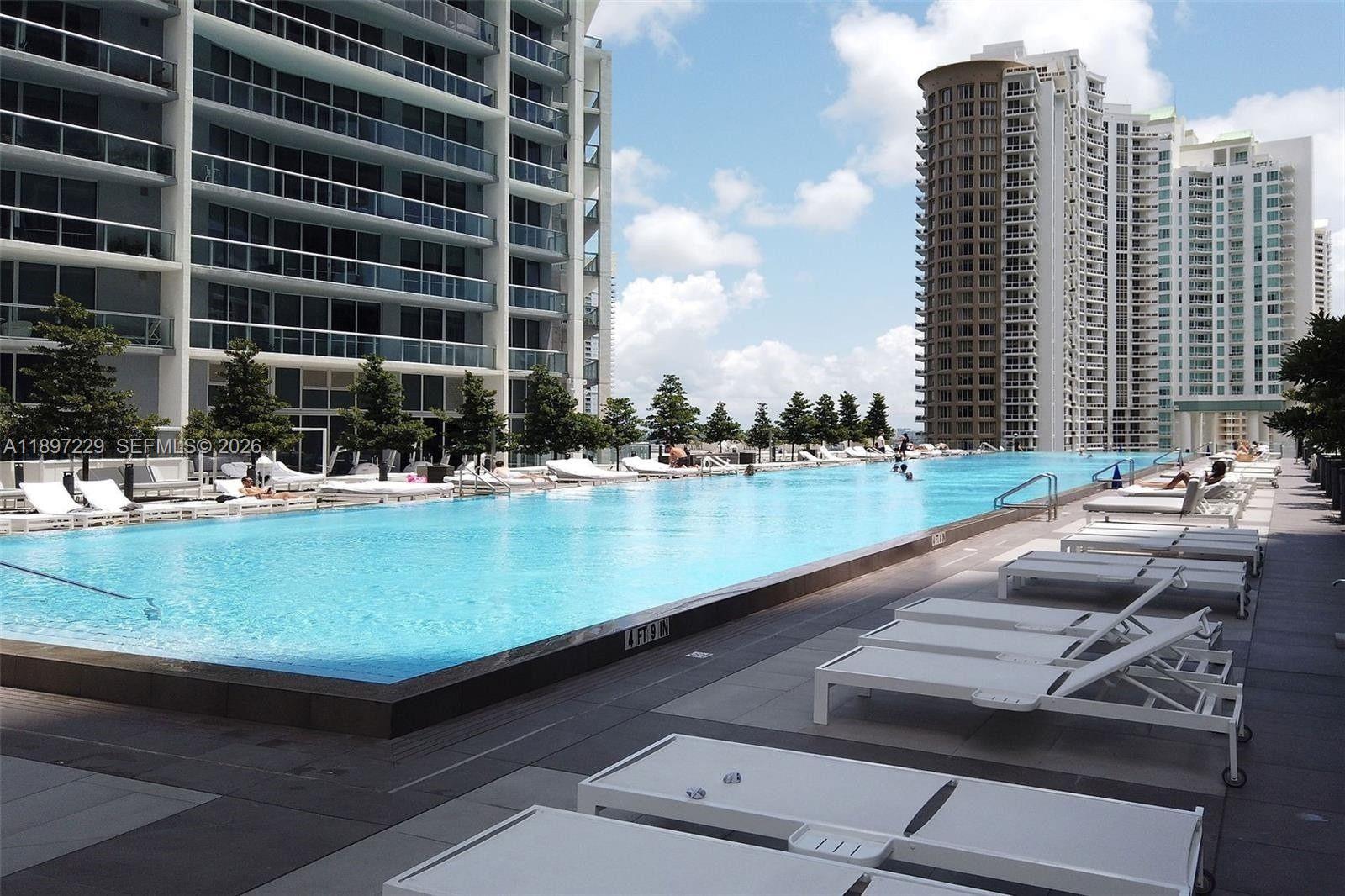 495 Brickell Avenue, Unit 2301 Miami, FL 33131 - Photo 49 of 61 a view of swimming pool with outdoor seating and lake view