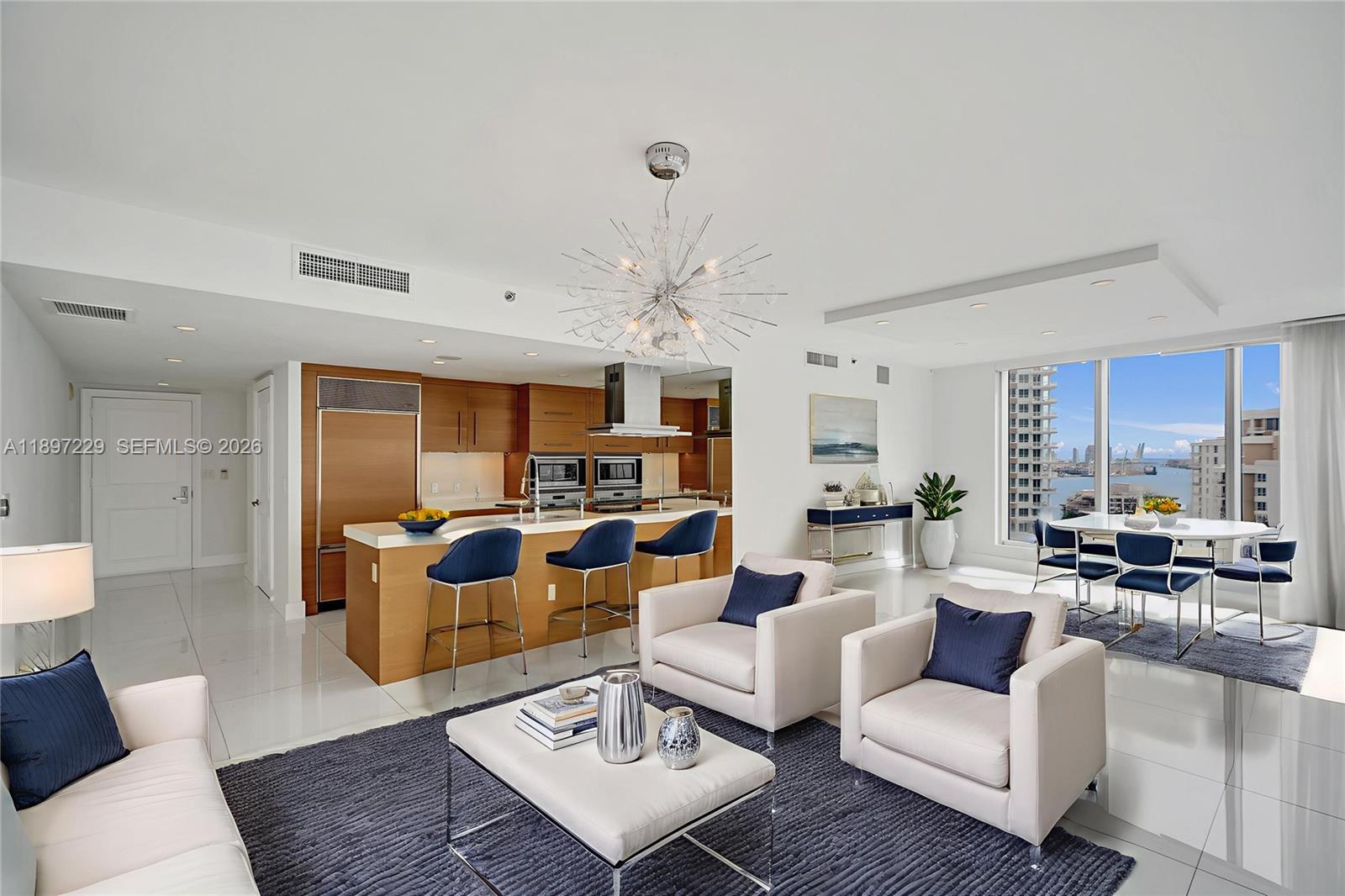 495 Brickell Avenue, Unit 2301 Miami, FL 33131 - Photo 7 of 61 a living room with furniture kitchen view and a chandelier