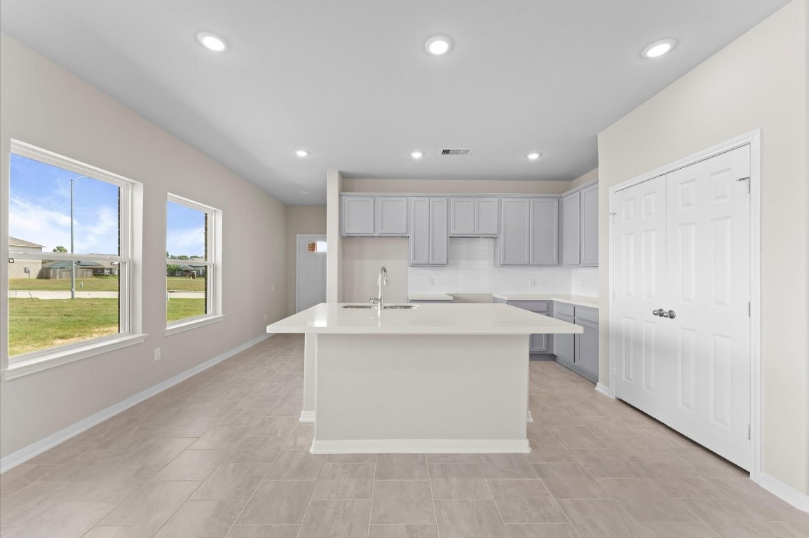 1354 Mixander Way La Porte, TX 77571 - Photo 8 of 21 a large kitchen with kitchen island a large window a sink and a counter top space