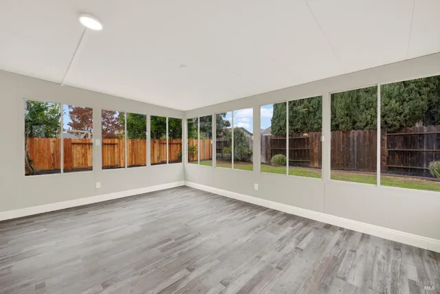 a kitchen with kitchen island granite countertop a sink wooden cabinets and stainless steel appliances