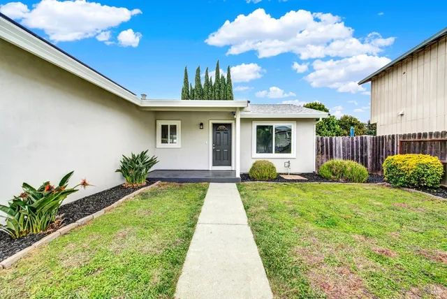 a front view of a house with garden