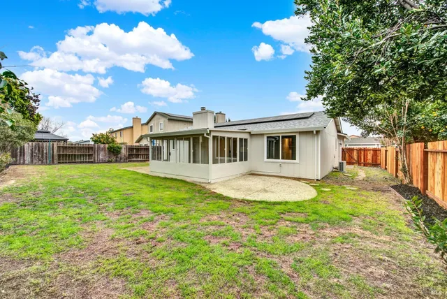 a view of a house with backyard and balcony
