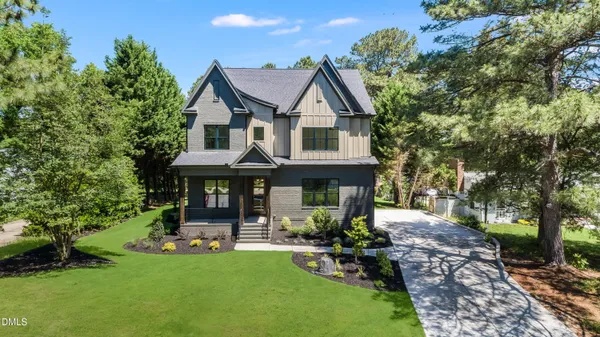 a front view of a house with swimming pool garden and patio