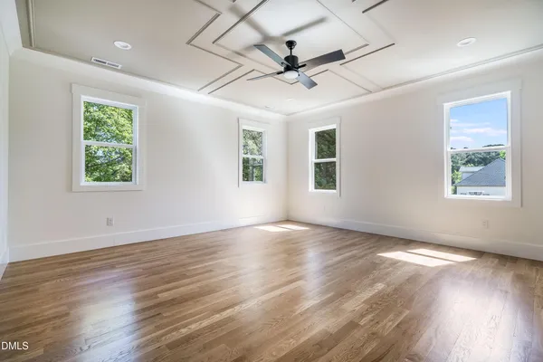 an empty room with windows and closet