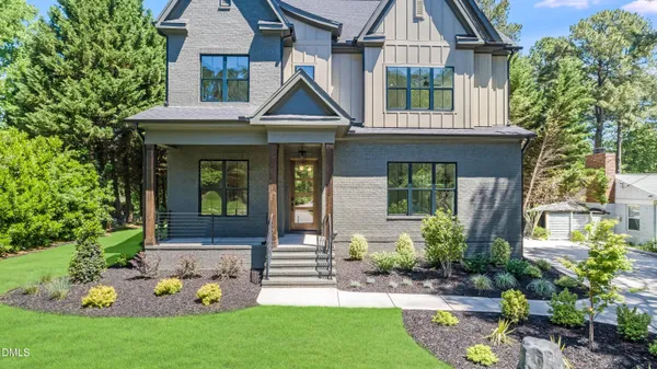 a front view of house with a garden