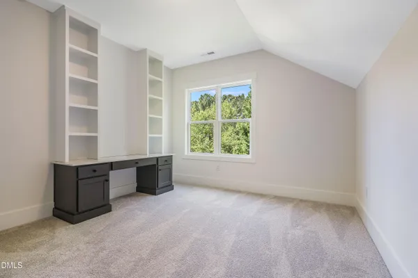 a large kitchen with stainless steel appliances kitchen island granite countertop a refrigerator and a stove top oven